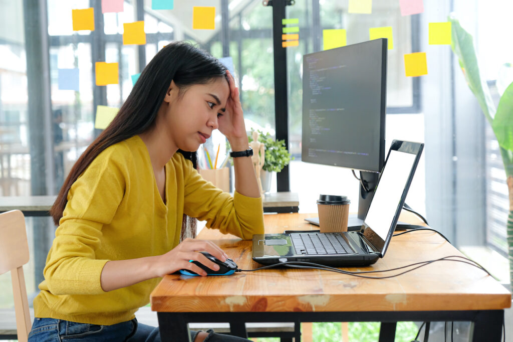 IT specialist working on laptop from office