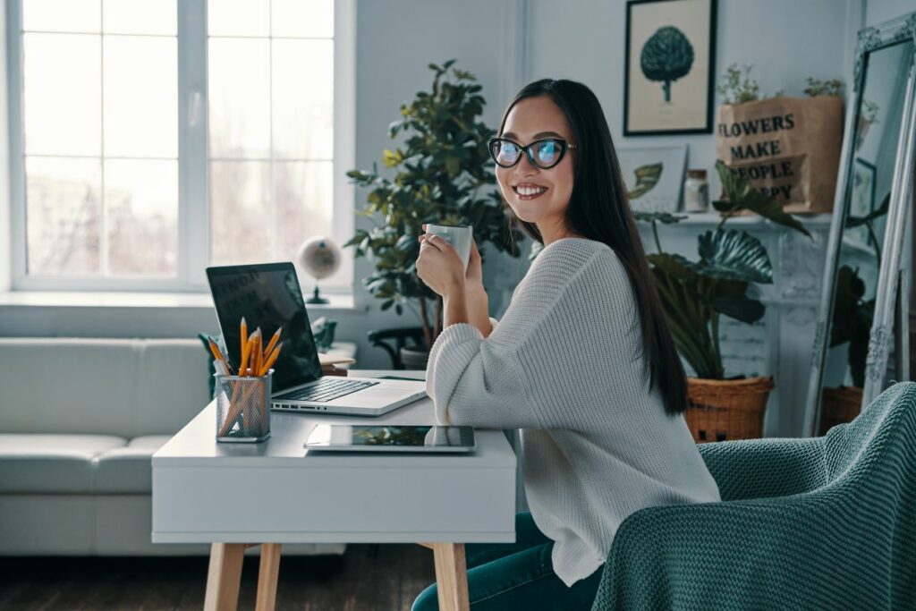 Woman smiling holding coffee