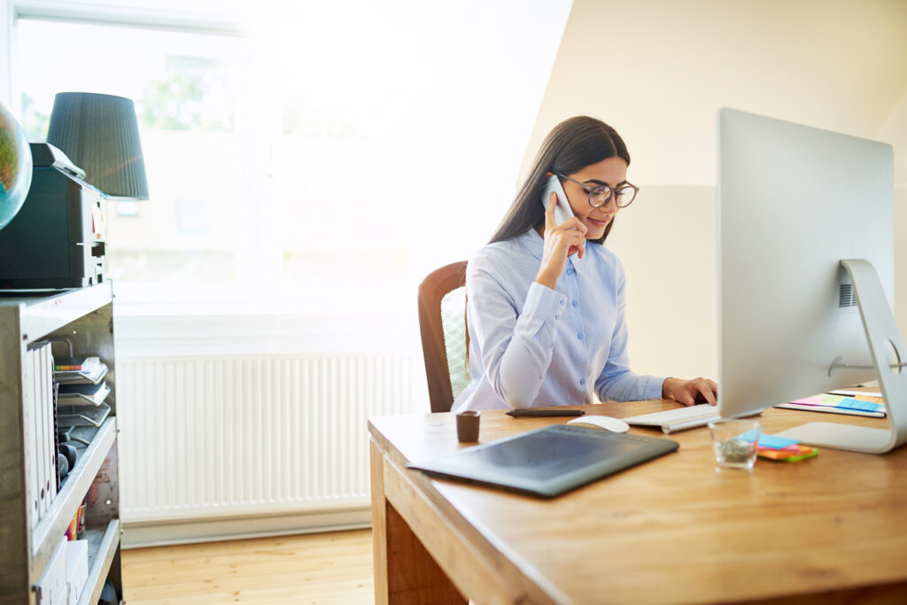 Woman working from home talking on the phone