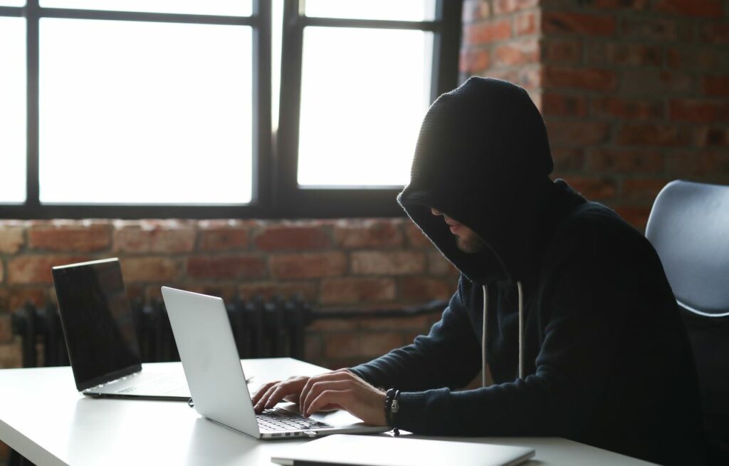 hacker on two laptops