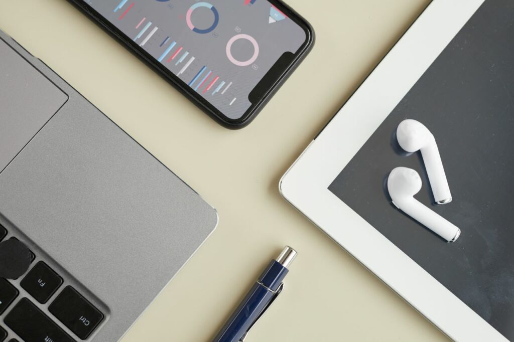 table with smartphone, tablet, and computer on it