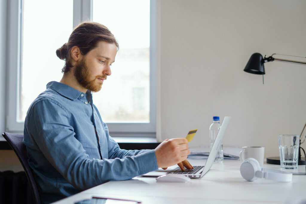 Man entering credit card information on his computer