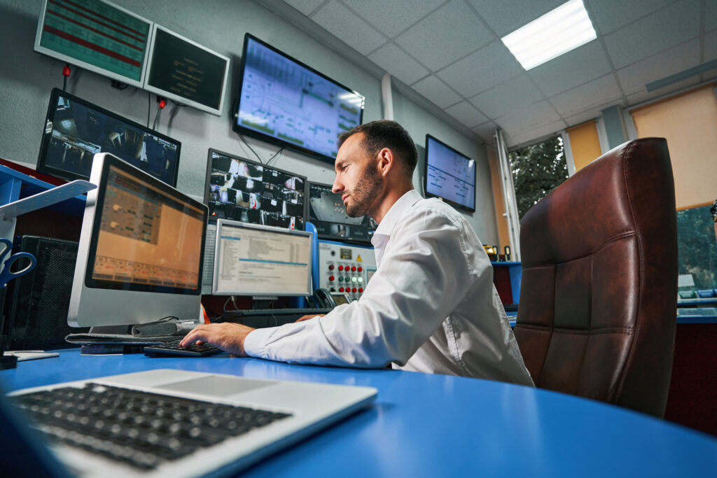 man managing network of data center from computer