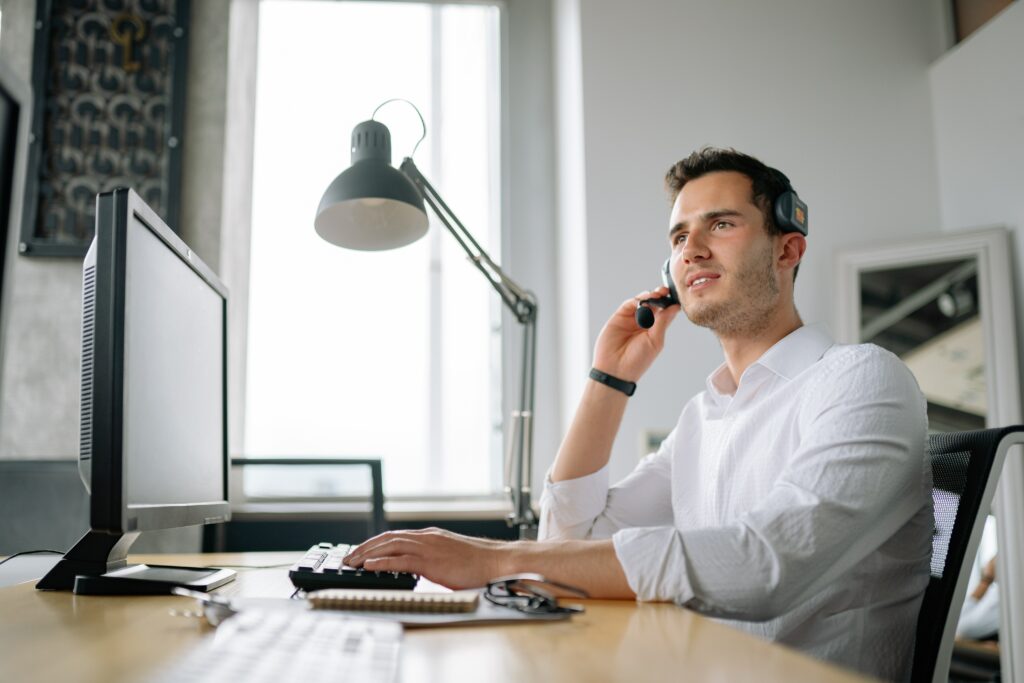 IT professional man on phone at computer