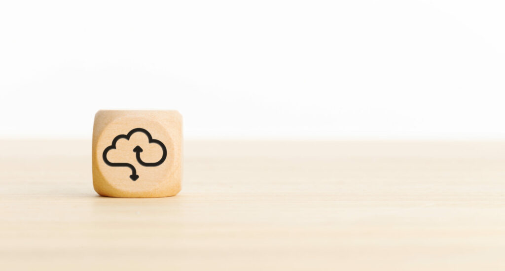 cloud on wooden block representing benefits of cloud computing