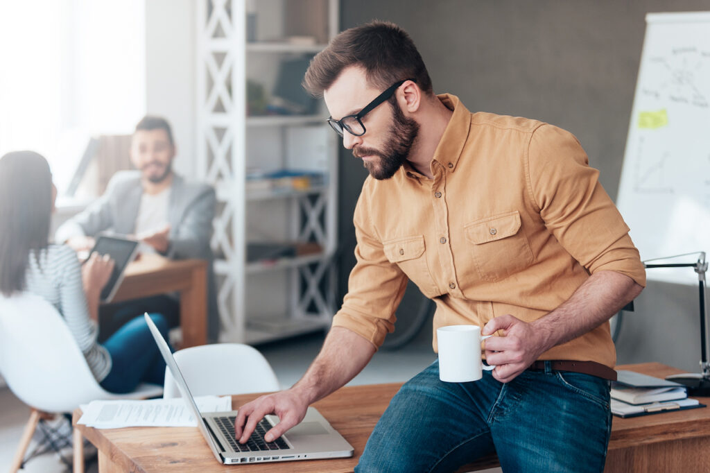 male worker at office implementing cyber security procedures