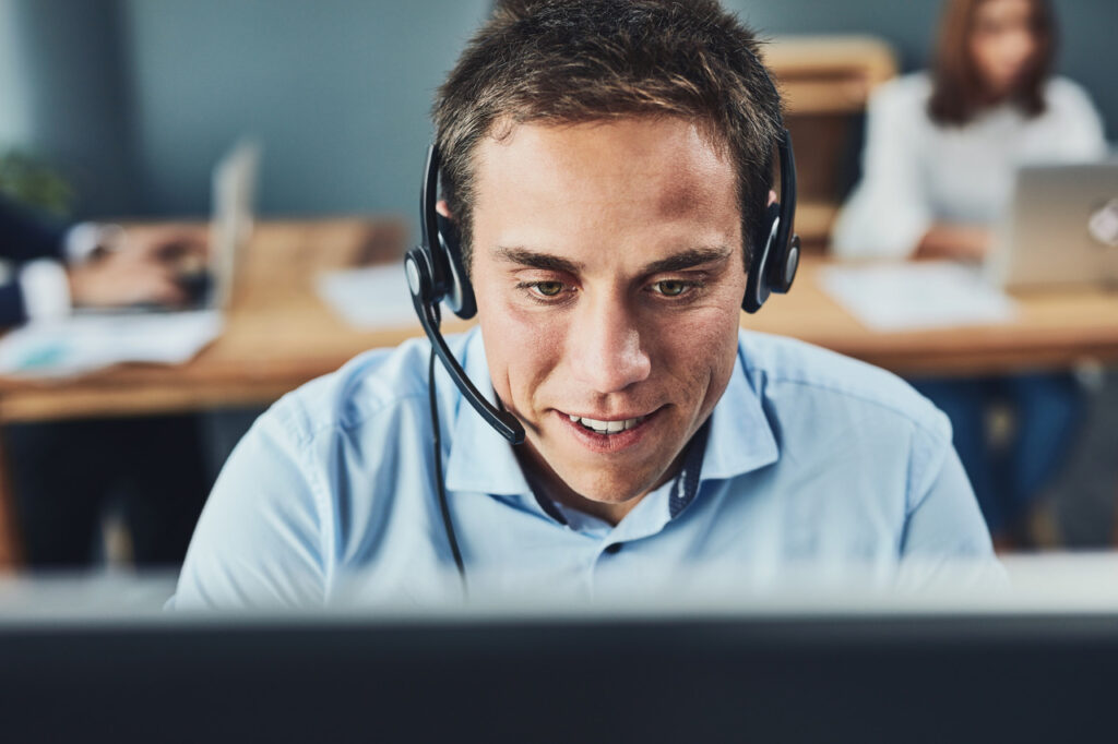 Man with a headset works at computer